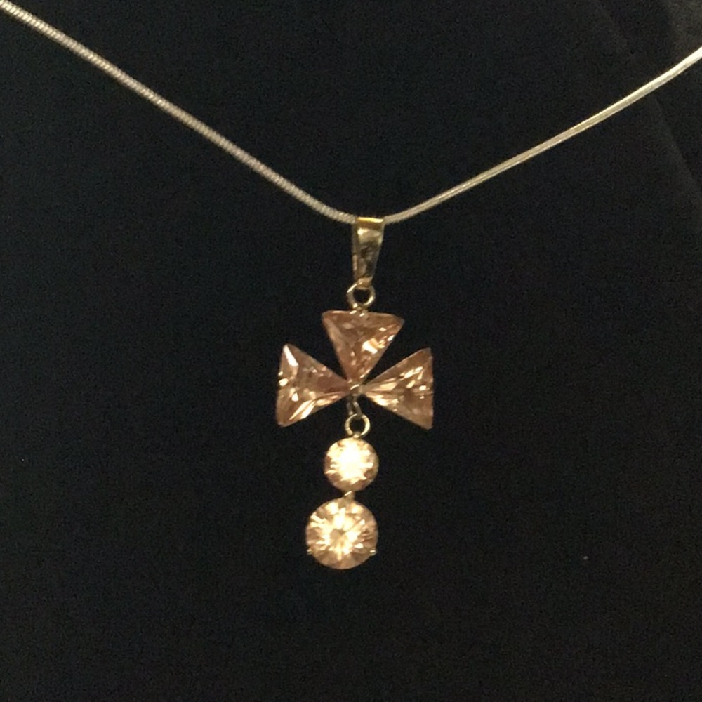 Golden colored ..swinging..cross. Real stones
